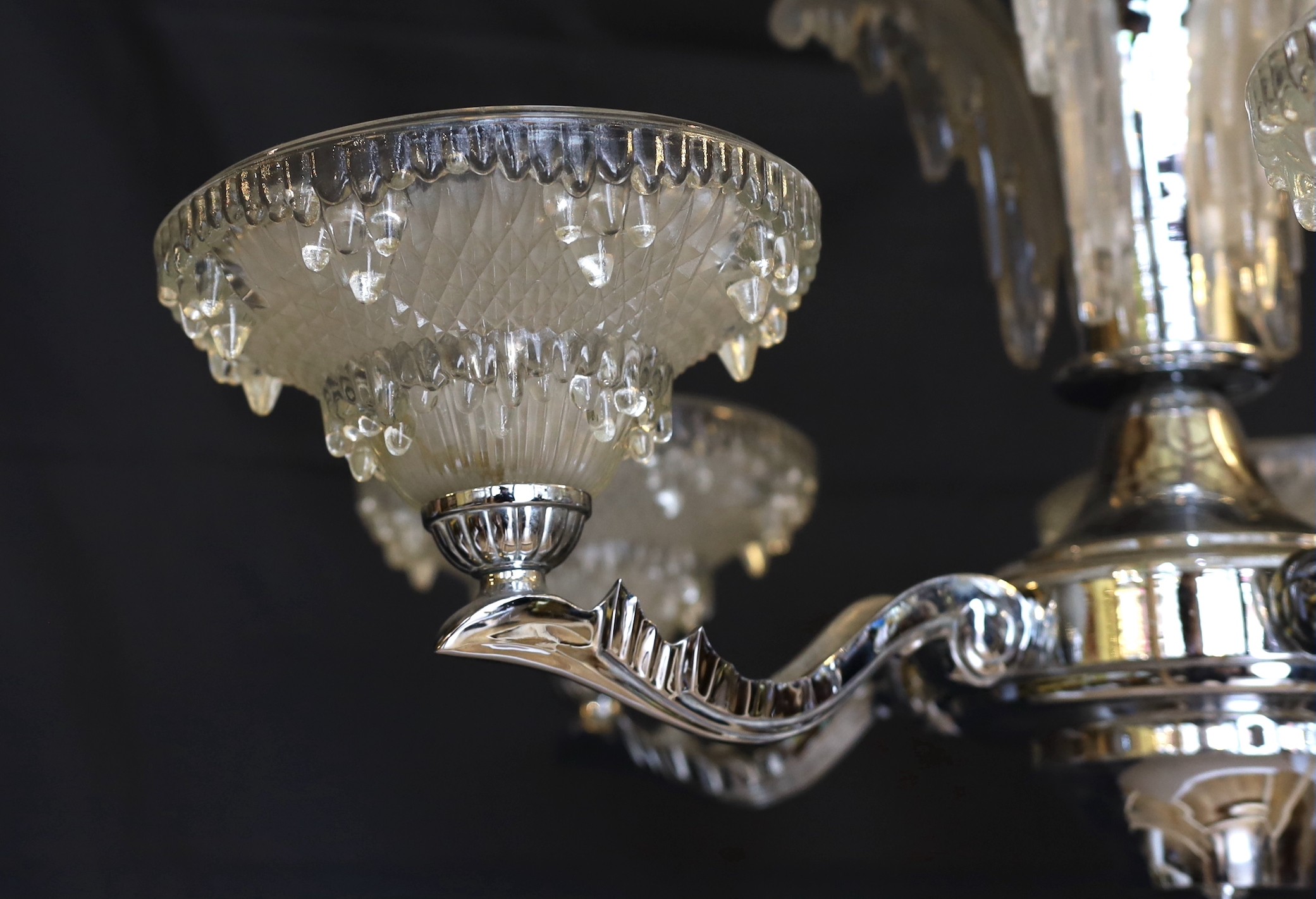 A French Art Deco chrome plated and glass five light chandelier, with scrolling branches and 'melting ice' mounts and shades, drop 85cm. width 70cm